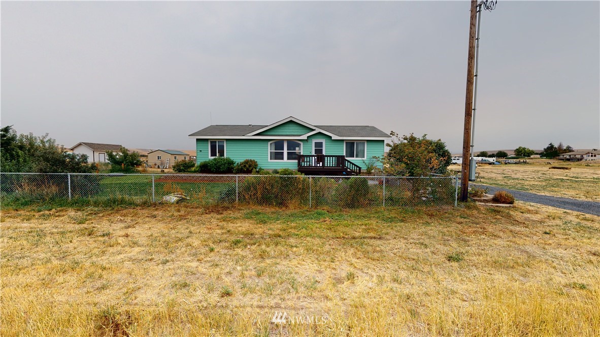 196 Skyrocket Road Prescott, WA 99348 - Photo 19 of 21 a view of a lake with a house in the background