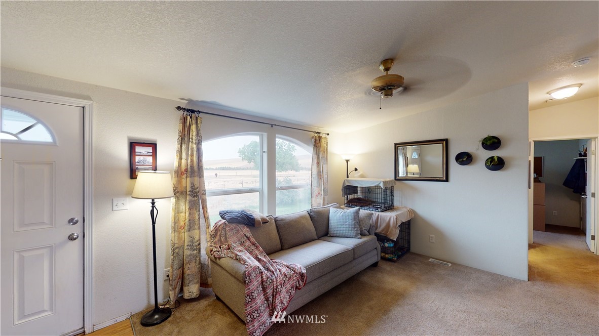 196 Skyrocket Road Prescott, WA 99348 - Photo 4 of 21 a living room with furniture and a large window