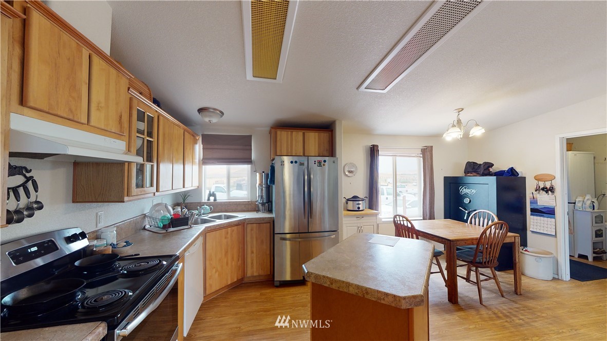 196 Skyrocket Road Prescott, WA 99348 - Photo 6 of 21 a kitchen with stainless steel appliances granite countertop a refrigerator and a stove top oven