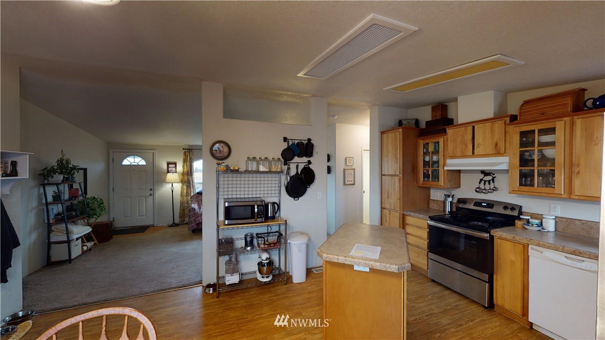196 Skyrocket Road Prescott, WA 99348 - Photo 7 of 21 a kitchen with stainless steel appliances granite countertop a stove and a refrigerator