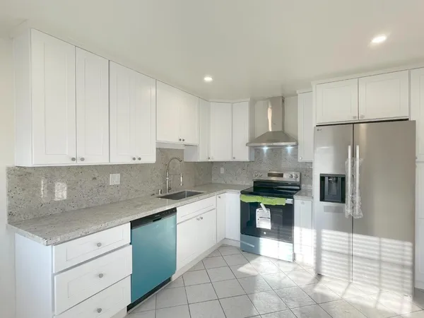 a kitchen with a stove a sink and a refrigerator