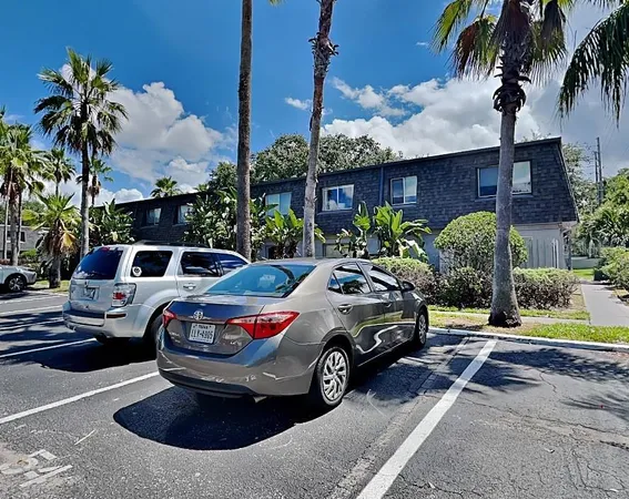 a front view of a house with parking space