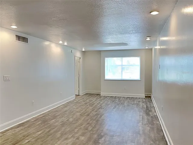 an empty room with windows and closet