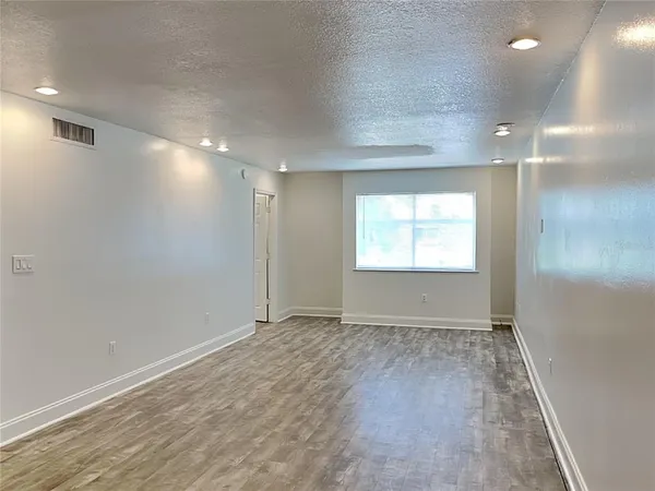 an empty room with windows and closet
