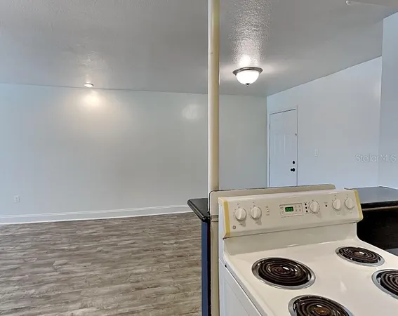 a stove top oven sitting inside of a kitchen