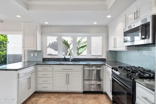 a dining room with chandelier outdoor seating and yard