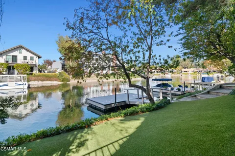 a view of a house with brick walls and a tree