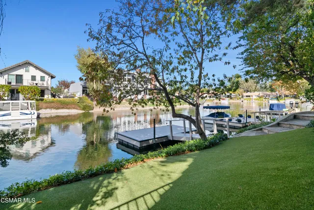 a view of a house with brick walls and a tree