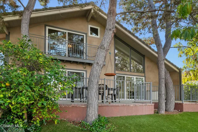 a view of a porch with chairs and backyard