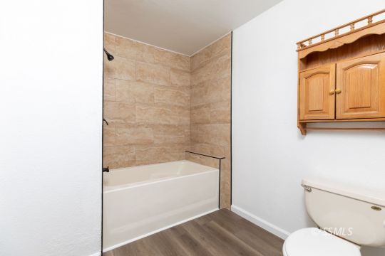 718 Sonja Avenue Ridgecrest, CA 93555 - Photo 23 of 33 a bathroom with a toilet and a bathtub