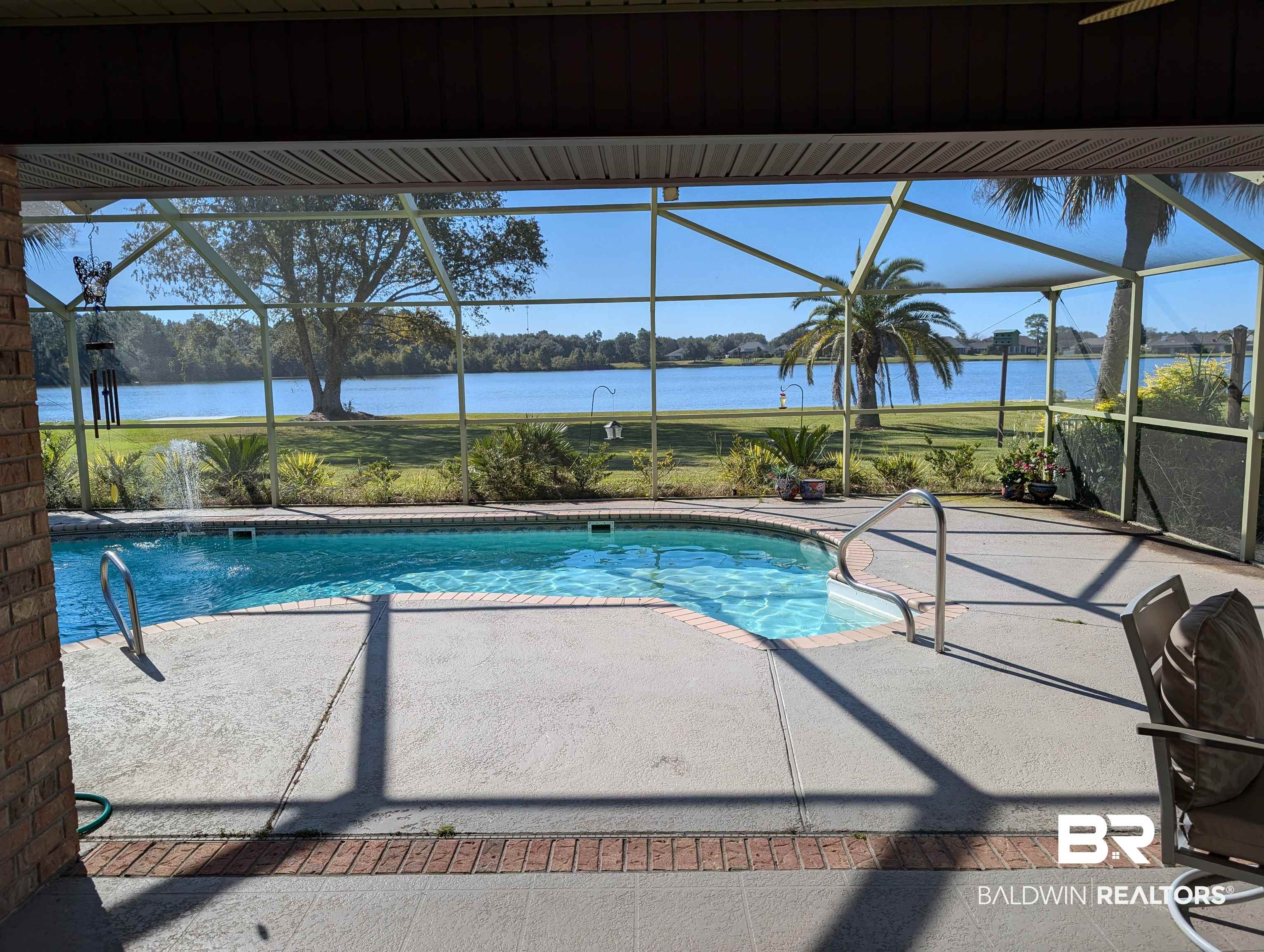 9462 Lakeview Drive Foley, AL 36535 - Photo 47 of 50 View of lake beyond palm tree and pool from covered patio