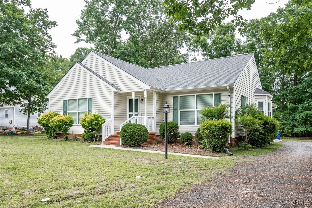 7427 Trailing Rock Road Prince George, VA 23875 - Photo 1 of 25 a front view of a house with garden