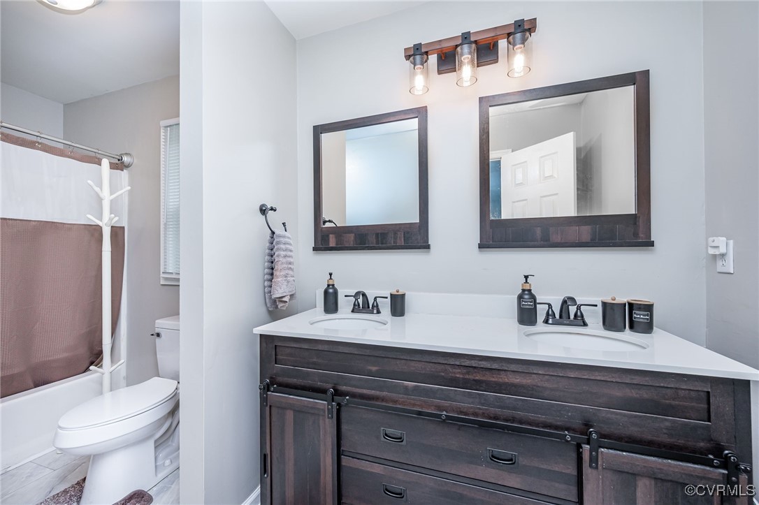 7427 Trailing Rock Road Prince George, VA 23875 - Photo 13 of 25 a bathroom with a toilet sink and mirror