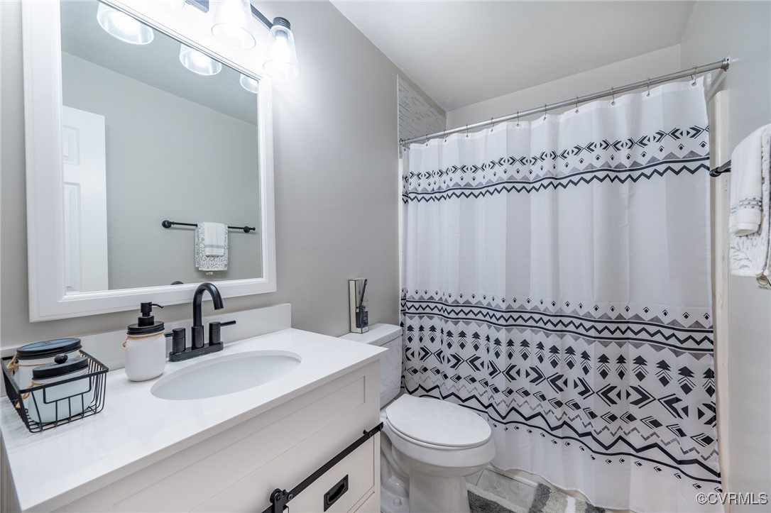 7427 Trailing Rock Road Prince George, VA 23875 - Photo 14 of 25 a bathroom with a sink toilet and shower