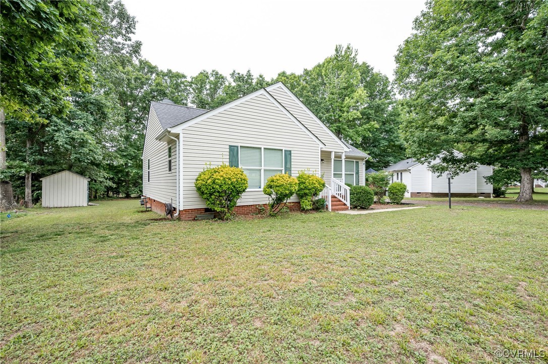 7427 Trailing Rock Road Prince George, VA 23875 - Photo 21 of 25 a view of a house with a yard and plants