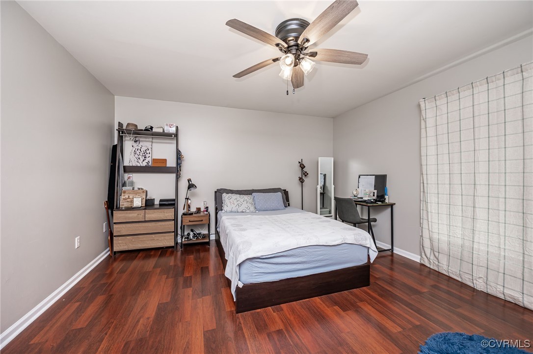 7427 Trailing Rock Road Prince George, VA 23875 - Photo 10 of 25 a bedroom with a bed and a chandelier