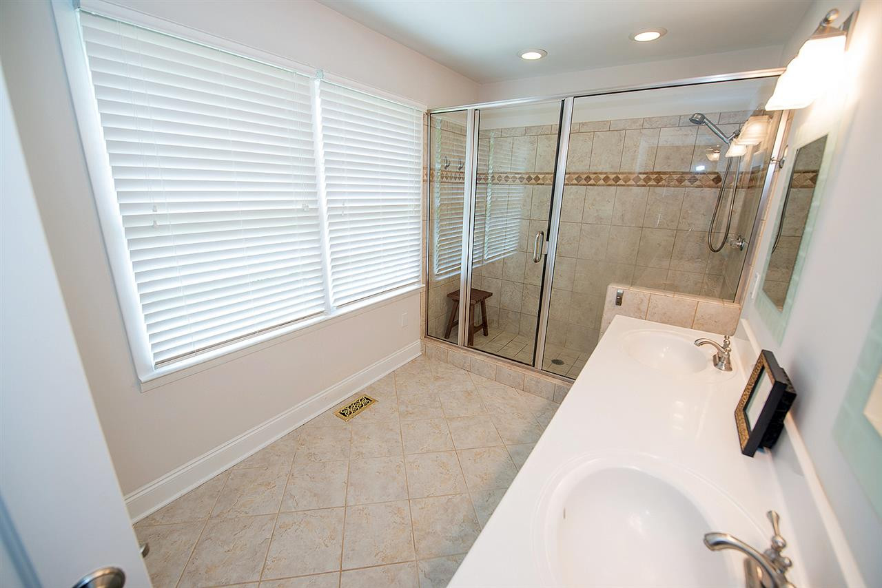 6820 Lake Wheeler Road Raleigh, NC 27603 - Photo 9 of 25 Master bathroom with dual sink marble vanity, walk-in closet, tiled shower and flooring.