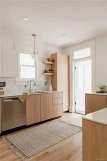 a large white kitchen with cabinets