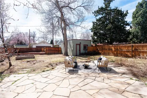 a view of a backyard with snow on the road