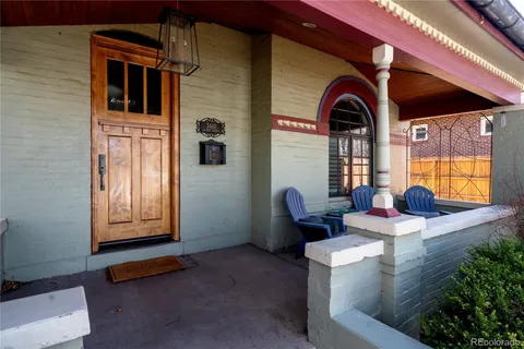 a front view of a house with outdoor seating