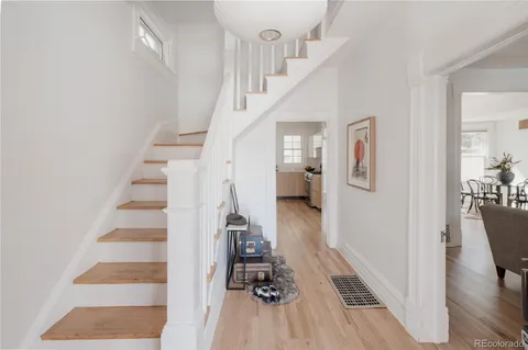 a view of entryway and hall with wooden floor
