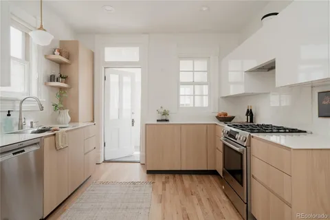 a kitchen with a sink stove and cabinets
