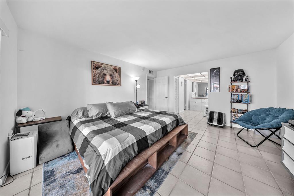 13700 Southwest 62nd Street, Unit 149 Miami, FL 33183 - Photo 8 of 16 a bed room with a bed and dresser