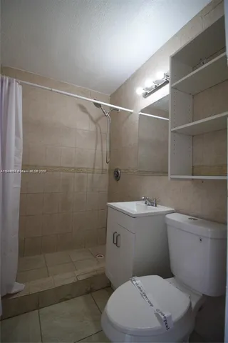 a bathroom with a toilet and shower