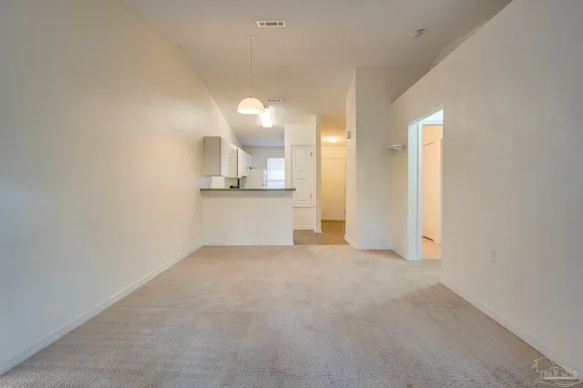 a view of a kitchen with a sink and cabinets
