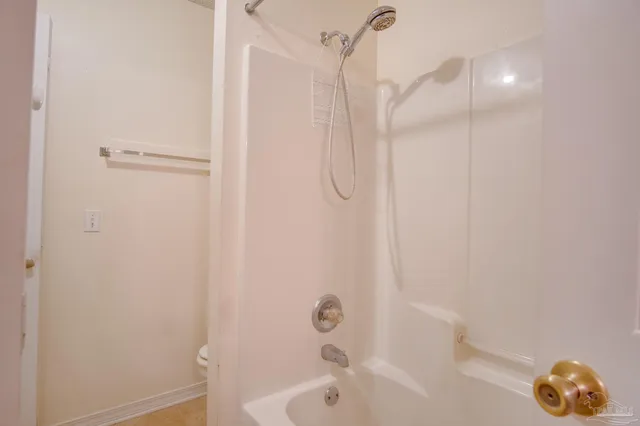 a bathroom with a bathtub and shower
