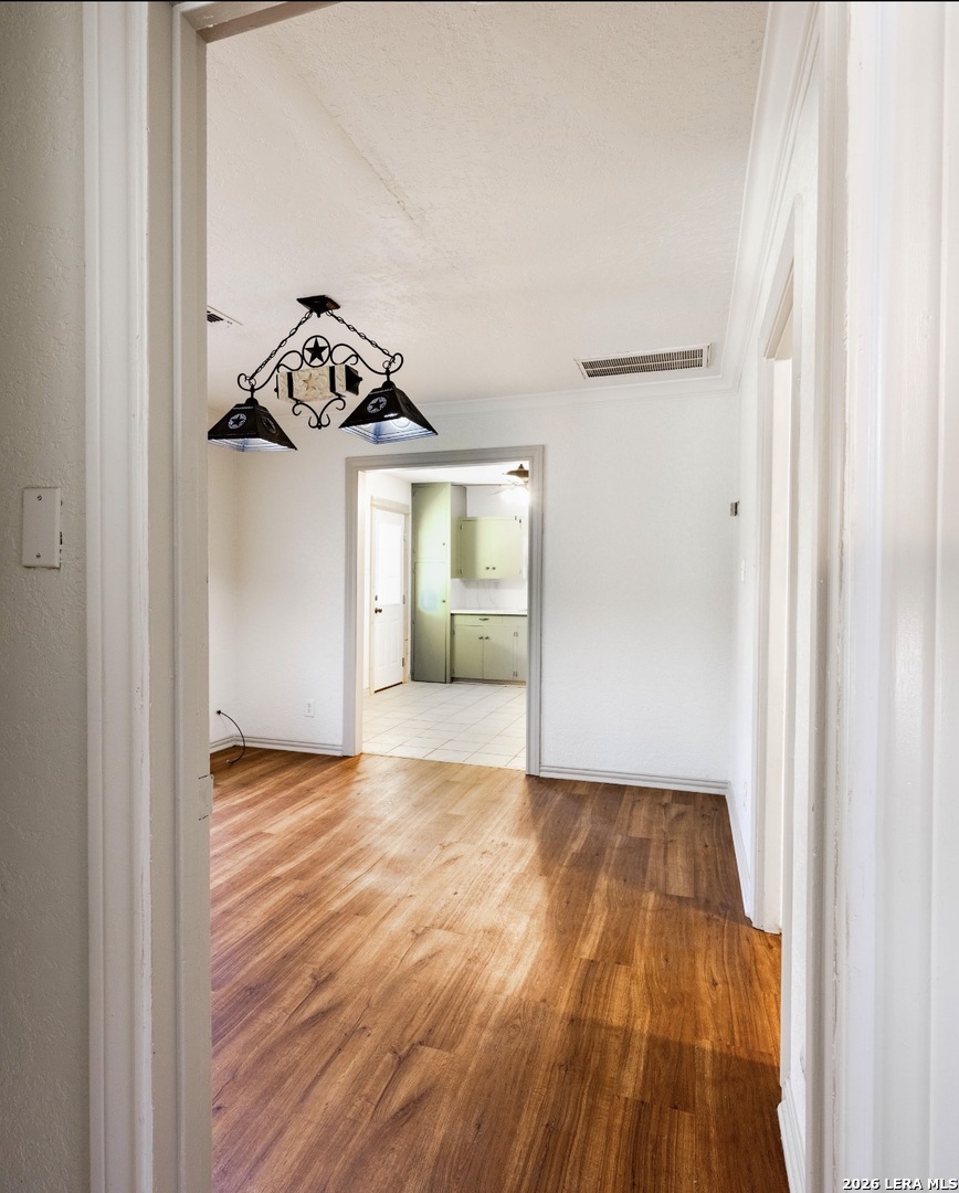 149 South Carroll Street Poth, TX 78147 - Photo 14 of 22 a view of a livingroom with wooden floor and a hallway