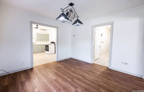 a view of empty room with wooden floor