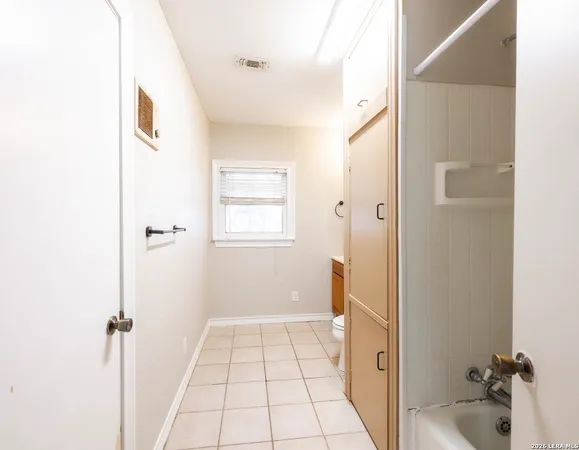 a bathroom with a tub and shower