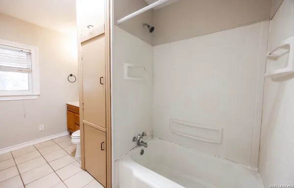 a bathroom with a tub and shower