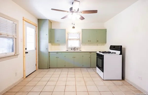 a kitchen with a stove a sink and a refrigerator