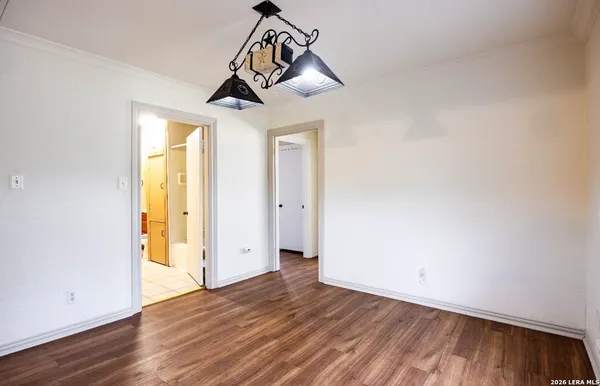 a view of a room with wooden floor and windows