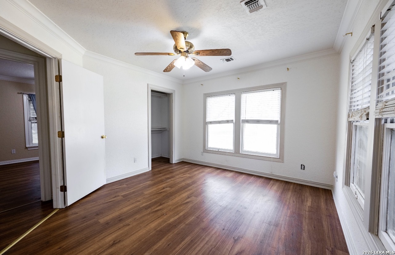 149 South Carroll Street Poth, TX 78147 - Photo 10 of 22 an empty room with wooden floor fan and windows