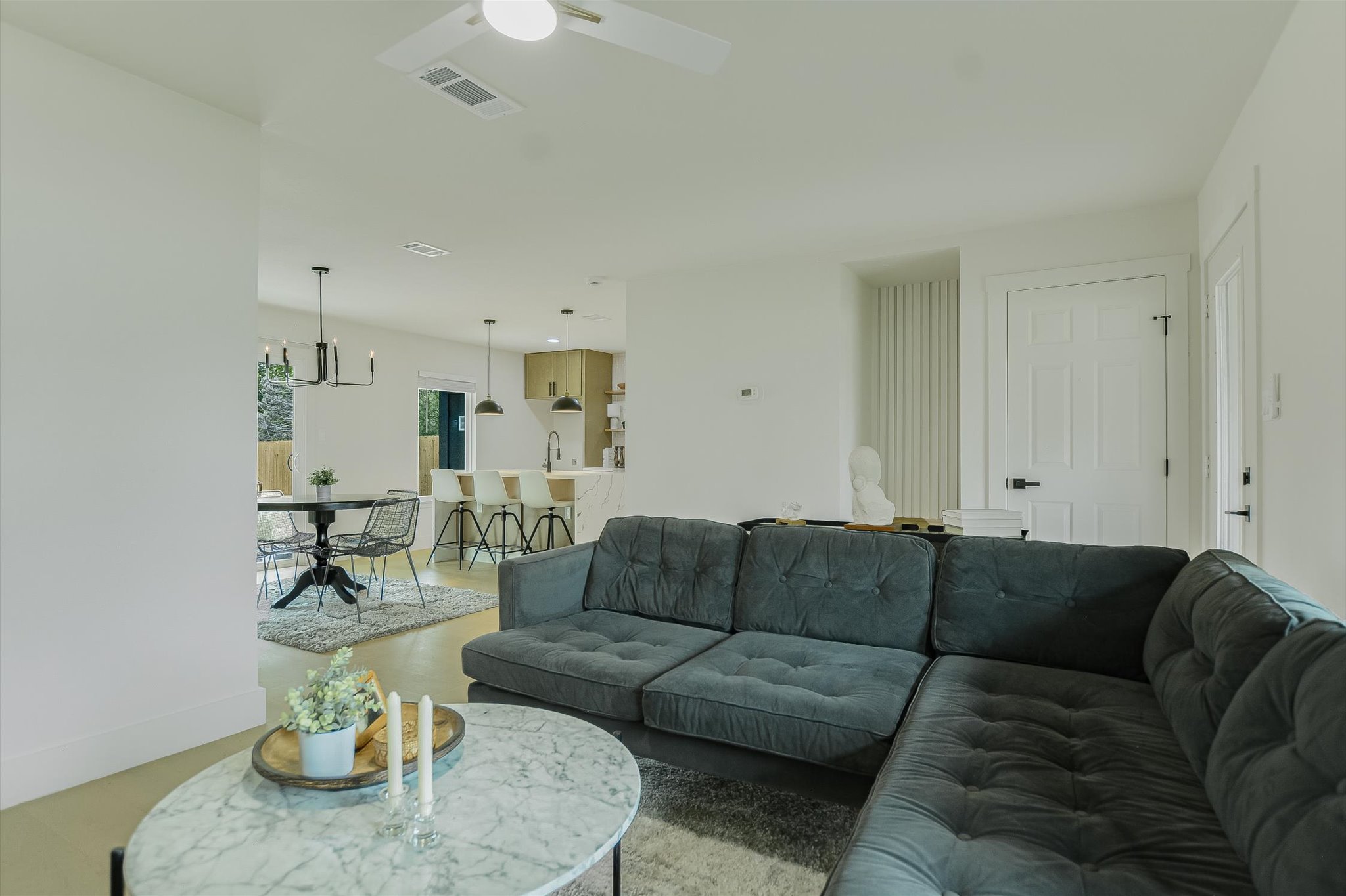 4505 Kitty Avenue Austin, TX 78721 - Photo 5 of 11 An open concept living area seamlessly connects to a modern kitchen and dining space.