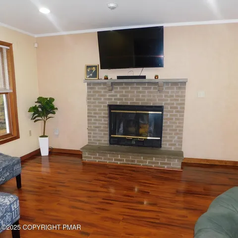 a living room with furniture a flat screen tv and a fireplace