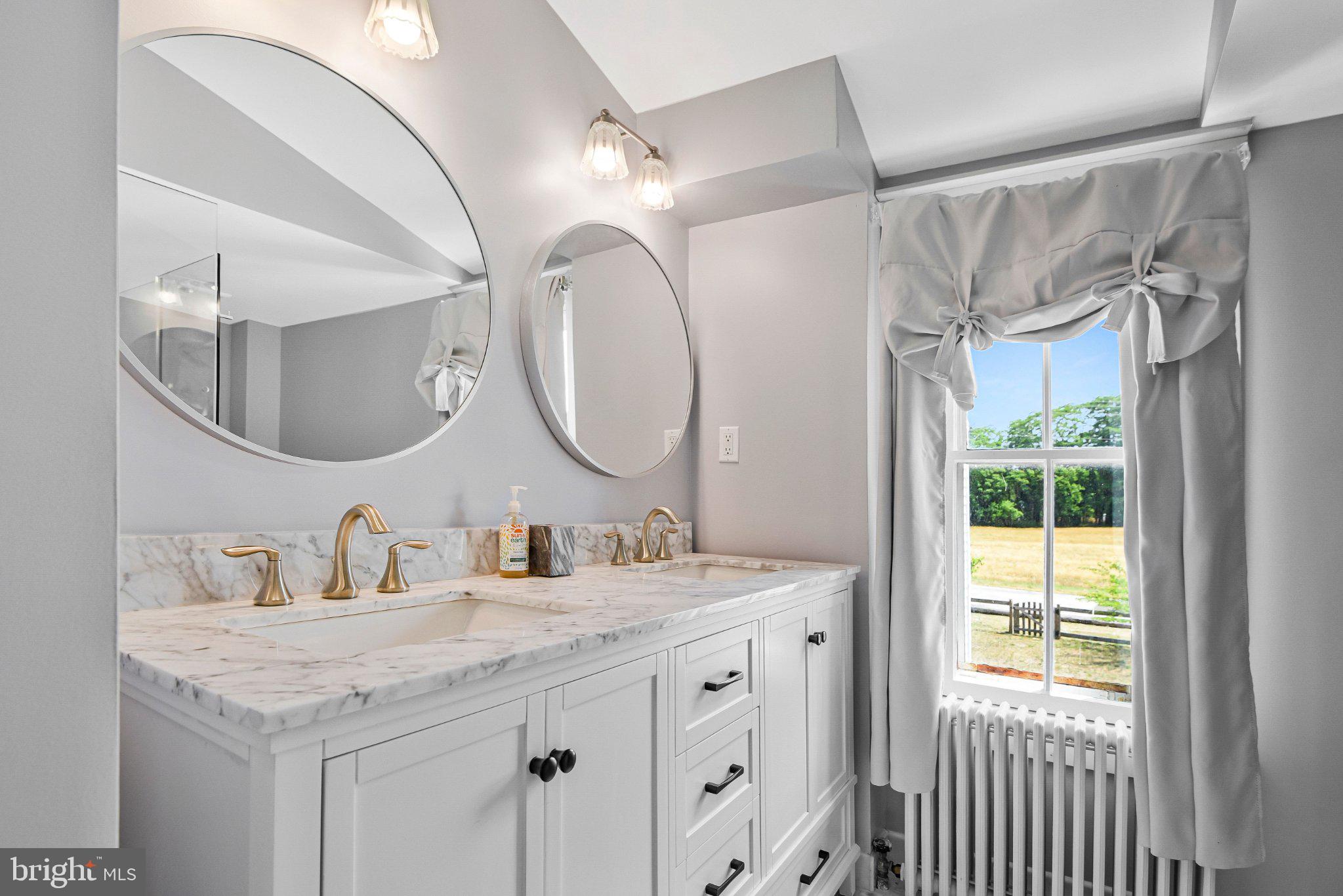 22109 Aquasco Road Aquasco, MD 20608 - Photo 32 of 34 Elegant dual-sink bathroom retreat.