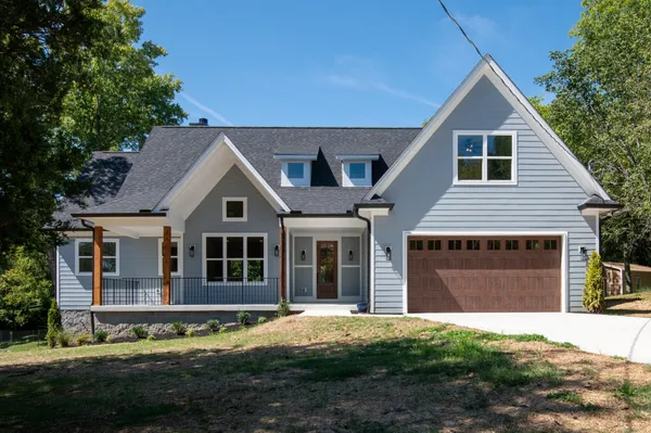 a front view of a house with a yard and garage