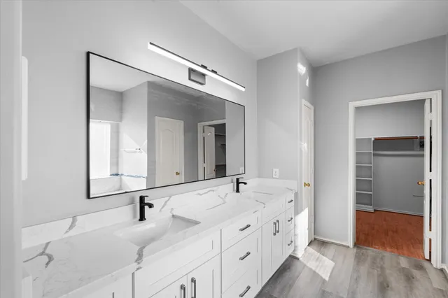 a bathroom with a double vanity sink and mirror