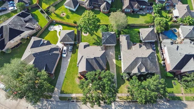 an aerial view of houses with yard