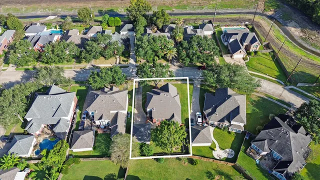 an aerial view of a house a garden and swimming pool