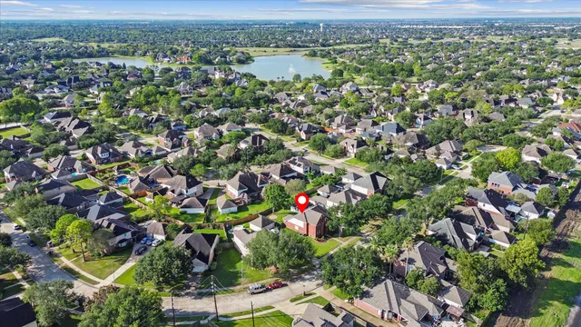 an aerial view of residential houses with outdoor space and covered with swimming pool