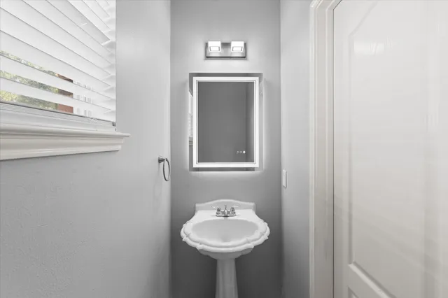 a bathroom with a sink and a mirror