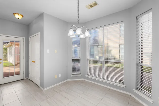 a view of a room with windows and chandelier