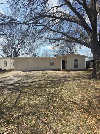 a kitchen with a stove and a wooden floor