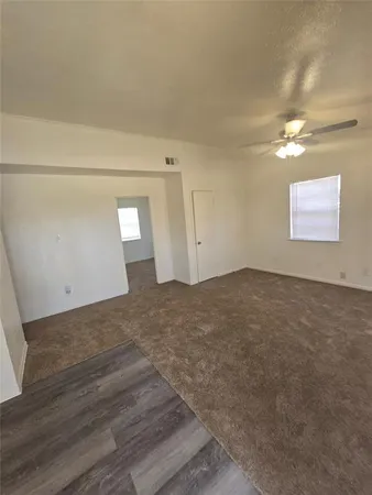 a view of a room with wooden floor and windows