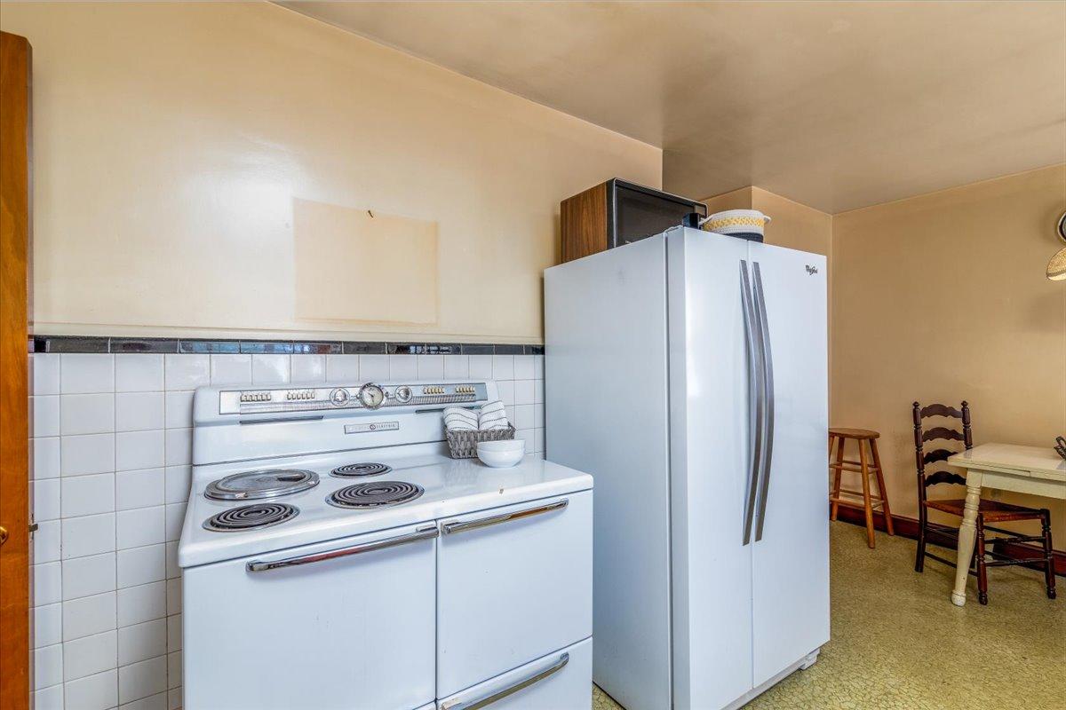 2510 Tillett Road Southwest Roanoke, VA 24015 - Photo 11 of 27 a kitchen with a refrigerator and a stove top oven